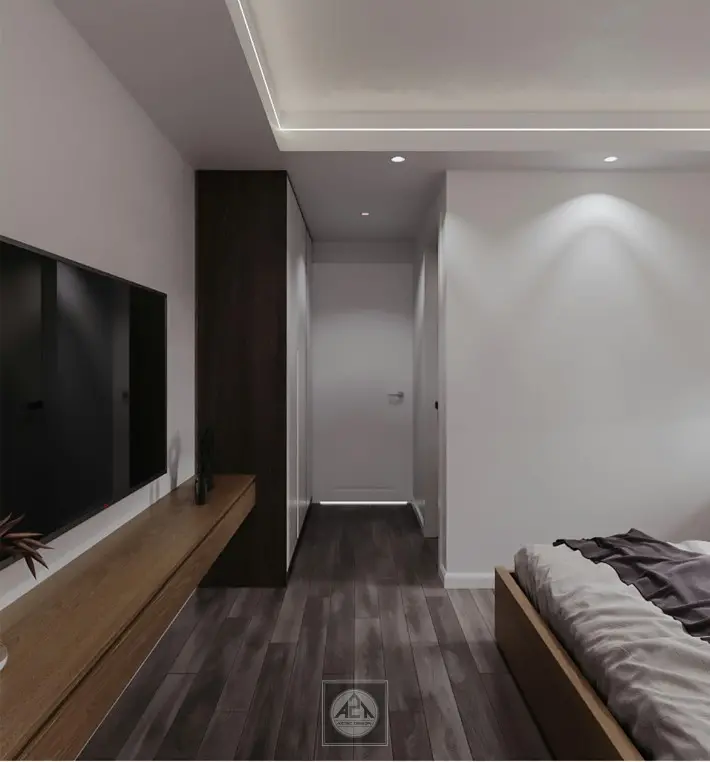 A room with a bed and a tvDescription automatically generated